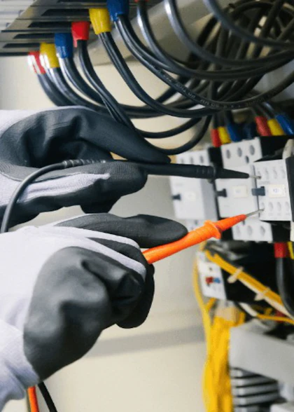 Technician testing an electrical panel